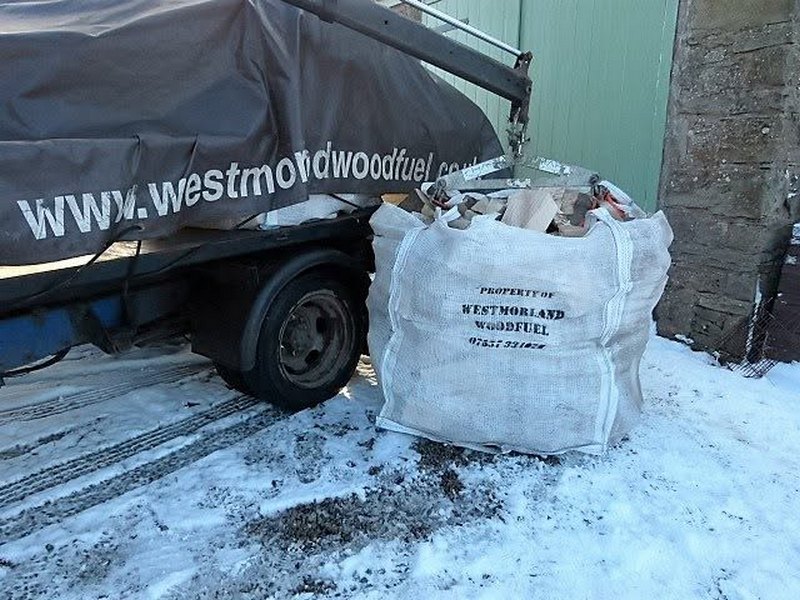 A dumpy bag of logs being delivered to a property in Cumbria by Westmorland Woodfuel